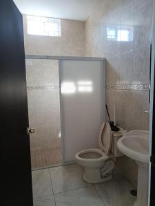a bathroom with a toilet and a sink at Posada don rulo in Mazatlán