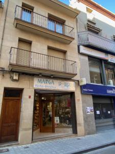 a store front of a building on a street at Apartamento Dúplex Casa Jares in Caspe