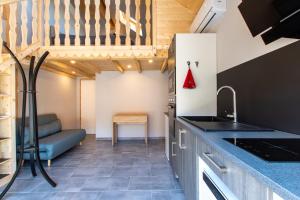 a kitchen with a sink and a couch in a room at Apartment type f1 to in Sainte-Hélène-sur-Isère +7 photos