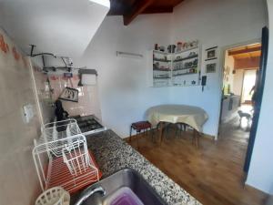 a kitchen with a sink and a table at Los nainos in Balneario Claromecó