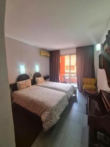 Postel nebo postele na pokoji v ubytování Hotel Tachfine