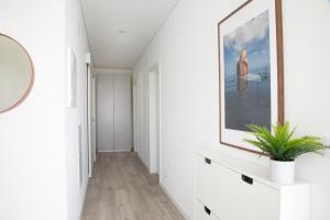 a hallway with a large painting on the wall at Premier Palaca - ground floor only, walk to reserve & town in Santo Isidoro