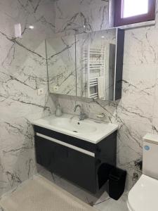 a white bathroom with a sink and a mirror at Villa Efes in Hisarcık +60 photos