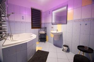a bathroom with a tub and a sink at Hubert in Białka Tatrzanska +27 photos