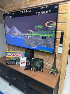 a table with a tv and a video game system at Storm Cottage in the Countryside in Parczów