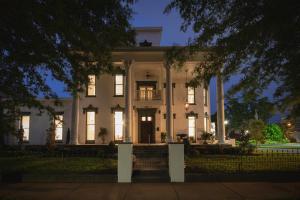 a large white house with a porch and columns at Belle Louise Historic Bed & Breakfast in Paducah