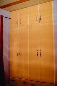 a row of wooden cabinets in a room at Prestige Villa Palace in Kigali