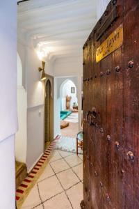 an old wooden door in a room with a living room at Riad Chill&Relax Dar Tayri in Marrakech