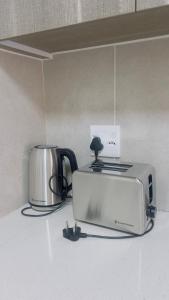 a toaster and a toaster oven on a counter at Nala Realty at The Aura in Sandton