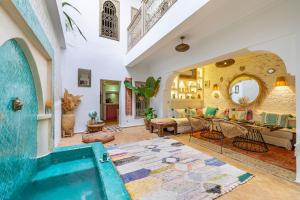 a living room with a swimming pool in a house at Riad Chill&Relax Dar Tayri in Marrakech +27 photos