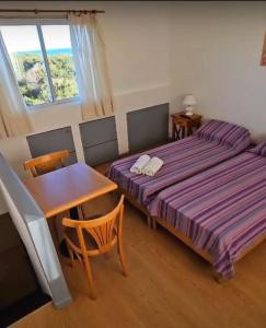a bedroom with a bed and a table and a desk at Amelia in Ostende +28 photos
