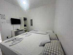 Postel nebo postele na pokoji v ubytování Hotel Aconchegante