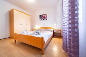 a bedroom with a bed in a room with a window at Apartment Kampor 1 in Kampor +40 photos