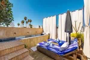 a patio with a table and chairs on a balcony at Riad Chill&Relax Dar Tayri in Marrakech