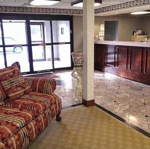 a living room with a couch and a kitchen at Lawrenceville Inn in Lawrenceville