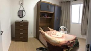 ein Schlafzimmer mit einem Bett, einer Kommode und einer weiteren Kommode in der Unterkunft Vivendas do Rio 1 in Ananindeua