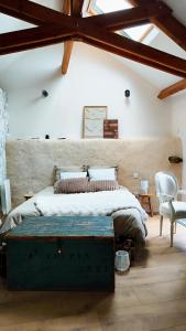 a bedroom with a large bed with a green trunk at Loulo 'dge in Saint-Donan