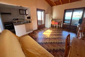 a kitchen with a couch and a table in a room at Appartement en bord de mer Marine de Sant-Ambrogio in Lumio