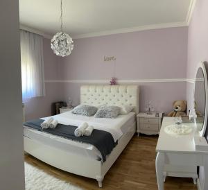 a bedroom with a white bed and a white table at Kuća za odmor ''ANA'' in Čitluk +13 photos
