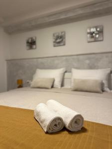 a bed with two rolled towels on top of it at Apartment Bilić in Pula
