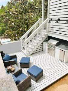 a porch with chairs and a stove on a house at The Eakes House on South 8th in Oxford