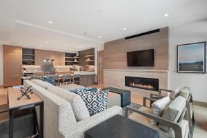 a living room with a couch and a fireplace at Snowmass Lux Getaway by Snowmass Vacations in Snowmass Village