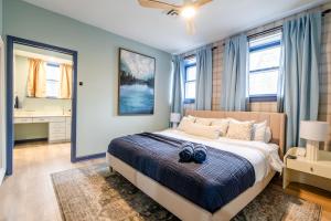 a bedroom with a large bed and a bathroom at SchoolHouse now Lux BNB! Gym, Sauna, HotTub, GameRoom in Union Pier +110 photos