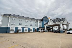 a large building with a parking lot in front of it at Country Inn & Suites by Radisson, Effingham, IL in Effingham