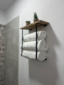 a stack of towels on a shelf in a bathroom at El Encanto de Jerez in Jerez de la Frontera +75 photos