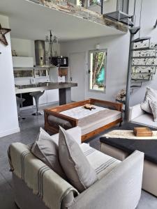 a room with a bed and a couch and a desk at Casa linda con pileta y parque in San Pedro +8 photos