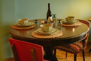 a table with two cups and a bottle of wine at Timeless nest in Alexandroupoli +51 photos