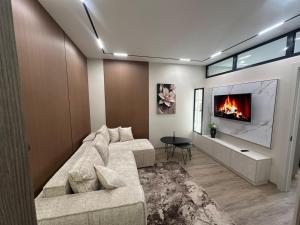 a living room with a couch and a fireplace at Privat Apartment Ciocana in Chişinău