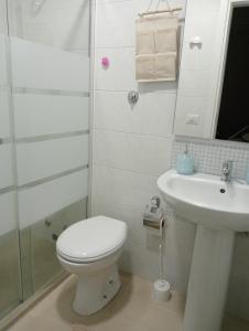a bathroom with a toilet and a sink at Le Perle in Maruggio