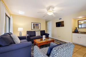 a living room with two couches and a table at Turtle Cove 4849 in Kiawah Island