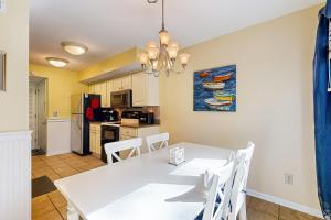 a kitchen and dining room with a white table and chairs at Turtle Cove 4849 in Kiawah Island +19 photos