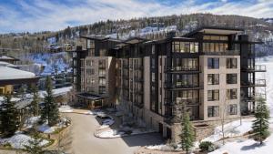 a rendering of a large building in the snow at Snowmass Lux Getaway by Snowmass Vacations in Snowmass Village