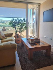 a living room with a couch and a coffee table at Estar Poético in Temuco