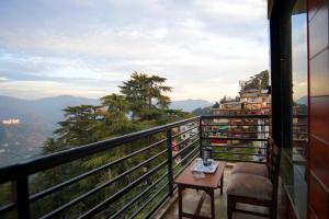 a balcony with a view of the mountains at Ambrosia Grand in Shimla