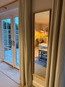 a mirror in front of a room with a bedroom at The Nook in Holbeach