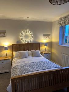 a bedroom with a large bed with two night stands at The Nook in Holbeach