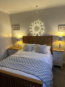 a bedroom with a large bed with two night stands at The Nook in Holbeach