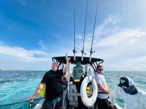 a group of men on a boat in the ocean at Coba Belize in San Pedro