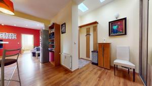 a living room with red walls and wooden floors at SAG apartment close to the castle free parking in Bratislava +12 photos