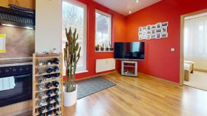 a living room with red walls and a tv at SAG apartment close to the castle free parking in Bratislava