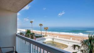 a balcony with a view of the beach and the ocean at Oceanfront Studio in Daytona Beach Resort in Daytona Beach