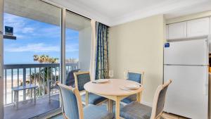 a dining room with a table and chairs and a balcony at Oceanfront Studio in Daytona Beach Resort in Daytona Beach