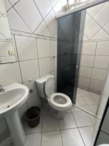 a bathroom with a toilet and a sink and a shower at Motel power in Belo Horizonte +22 photos