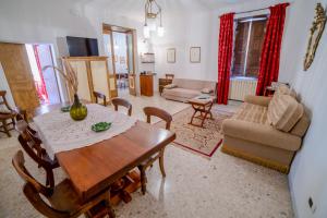 a living room with a wooden table and chairs at Casa Lanzara - Dimora Storica nel cuore del Pollino in Morano Calabro