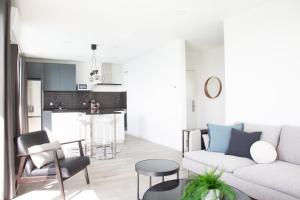 a living room with a white couch and a kitchen at Praceta Porthaus - entire private main home in Santo Isidoro +50 photos