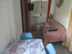 a small living room with a couch and a table at Bungalow Lolo Moringa in Bouillante